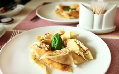Tasty pancakes on plate in cafe, close up