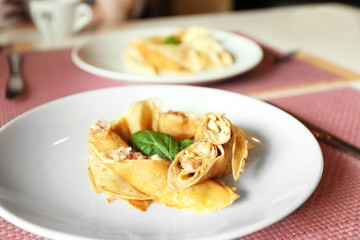 Tasty pancakes on plate in cafe, close up