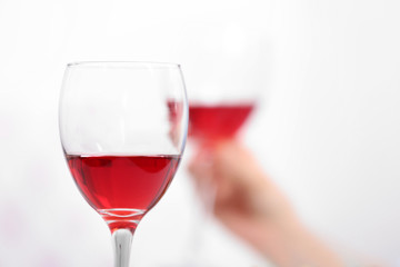 Dinner with glasses of wine on light blurred background