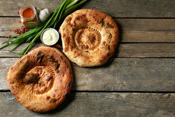 Fresh fried bread with other products on wooden background