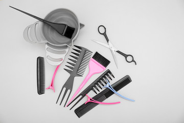 Fototapeta na wymiar Hairdresser set with various accessories on grey background