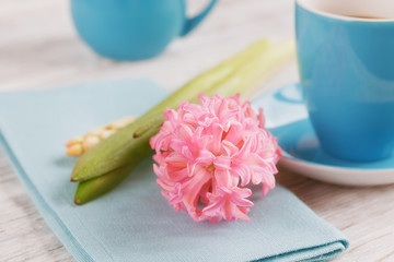 Cup of black coffee and pink flower