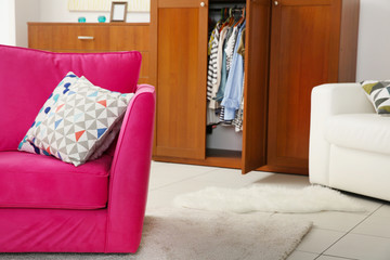 Pink armchair in modern interior of living room