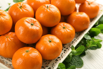 Fototapeta na wymiar Fresh, delicious tangerines on the white wooden table, close up
