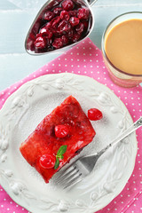 Cherry strudel with mint and cup of coffee