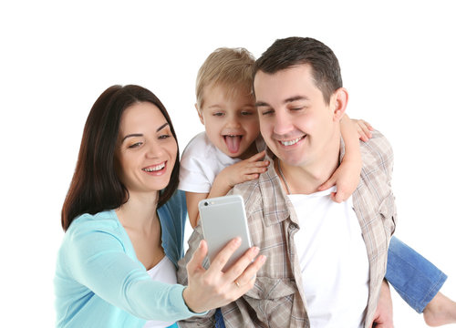 Happy family making selfie with mobile phone isolated on white