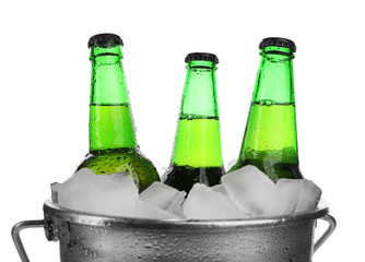 Beer bottles in ice bucket, isolated on white
