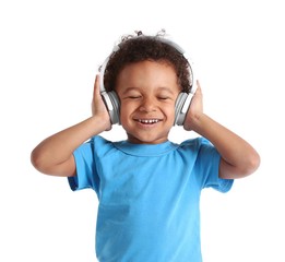 Little boy in blue shirt wearing headphones isolated on white background