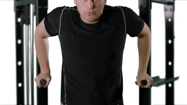 Man working out at the gym.  Slow motion, medium close up with clean white background.  Originally recorded in 12-bit 4K RAW at 60fps against green screen.