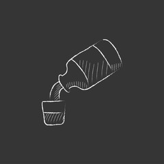 Medicine and measuring cup. Drawn in chalk icon.