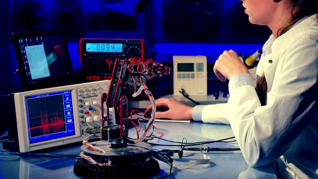 cientist adjusts the robot arm