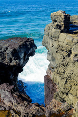 The wave breaks against neighboring rocks. Gris Gris cape on South of Mauritius.