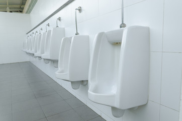 White urinals in men's bathroom, design of white ceramic urinals