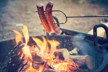 Tuinposter Preparing sausages on campfire, dinner on camping vacation  © Mariusz Blach