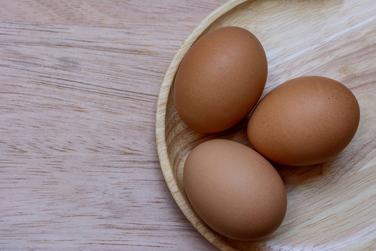 Eggs in plate on  wooden background