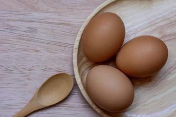 Eggs in plate on  wooden background