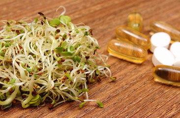Alfalfa and radish sprouts with tablets supplements, healthy nutrition