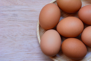 Eggs in plate on  wooden background