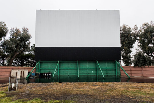 Drive in movie area with screen and speaker poles