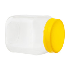 translucent turned jar with yellow cover for food. lying on its side