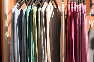 Detail of t-shirts on hangers in a street market in Italy