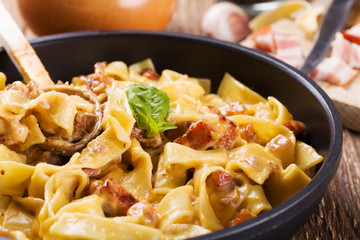 Pasta Carbonara with bacon, basil and cheese