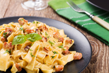 Pasta Carbonara with bacon, basil and cheese
