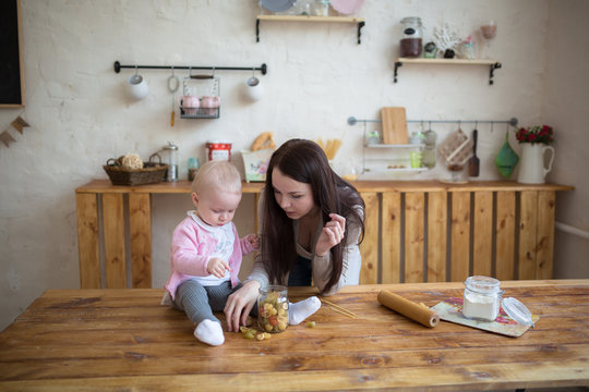 mother with her baby daughter in kitchen together cooking, lifes