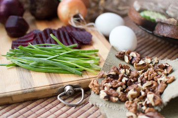 Chopped vegetables and nuts lying on a wooden board