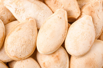 peeled pumpkin seeds or whole background macro