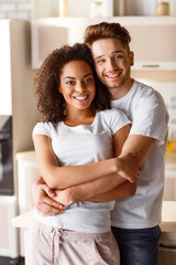 Nice couple embracing in the kitchen
