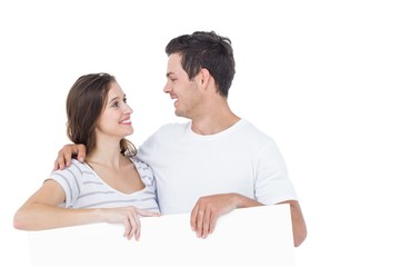 Happy couple holding a poster