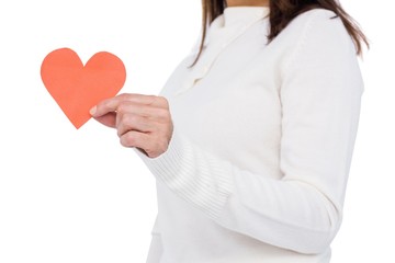 Cheerful brunette holding paper heart