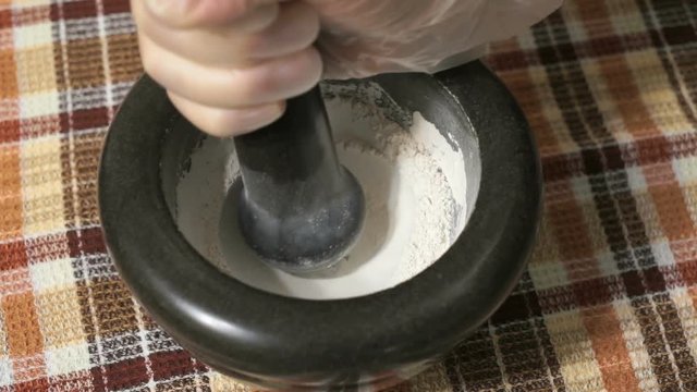 The grinding of the eggshell using mortar