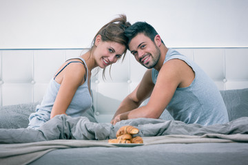 Young couple have breakfast in bed in the morning