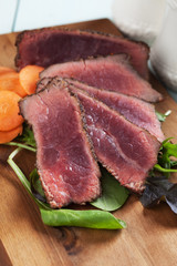 Rare beef steak with carrot and fresh salad