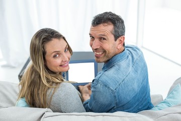 Couple using digital tablet