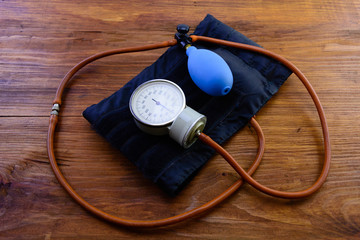 macro old medical mechanical tonometer on a wooden background