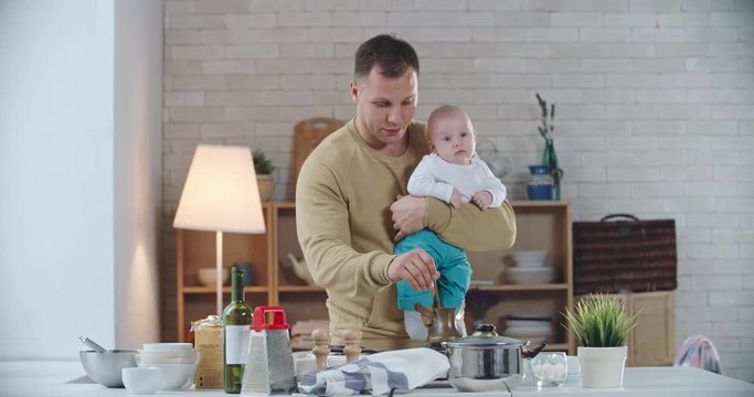 Happy father brewing coffee on stove and explaining his little son how to do it in a proper way