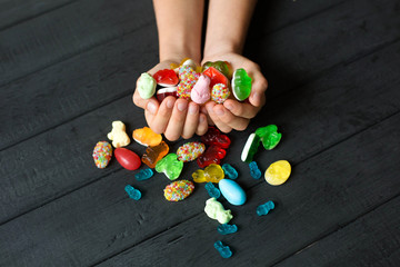 Kid's hands full of sweet candy