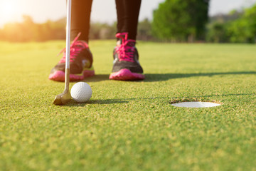 Golfer putting on green for birdie while on vacation