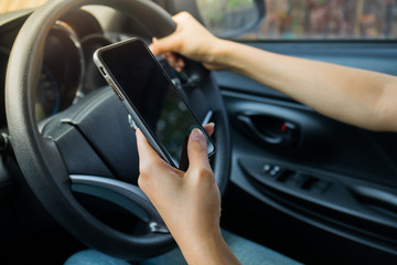 woman holding phone in car