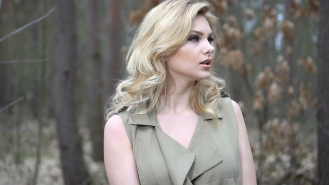 blonde woman running in the forest trying to escape 