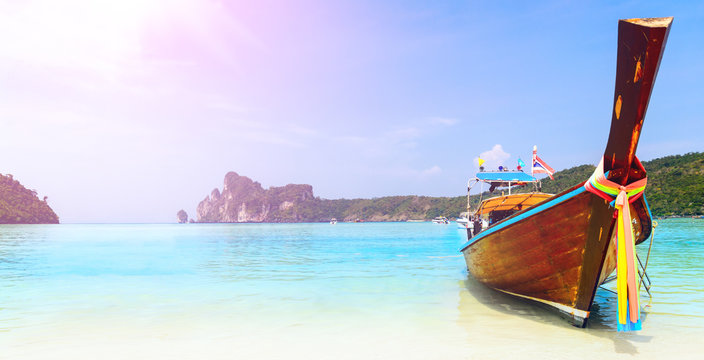 long boat at the beach with lens flare at koh Phi-Phi, Thailand