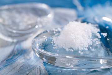 sea salt with glass heart on blue