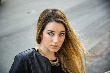 Young woman in black leather jacket outdoor