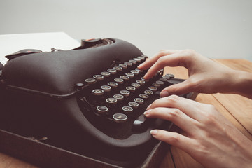 Vintage tone of Hands writing on old typewriter