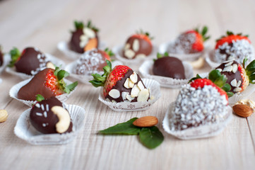 Variety of strawberries covered with milk and dark chocolate