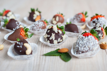 Strawberry covered with chocolate and almond nuts