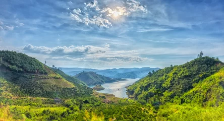 Foto op Plexiglas Heuvel Panorama sunset hillside Ta Dung hydro lake with mountains blue swirled large lake with islands, far away from the real little house idyllic rural countryside scene Vietnam
